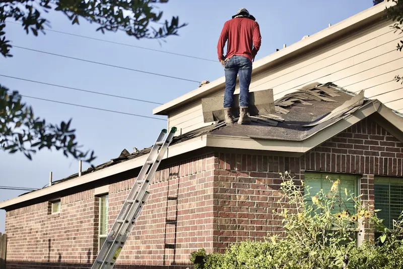 Professional roofer working on a residential roof in Goods Corner